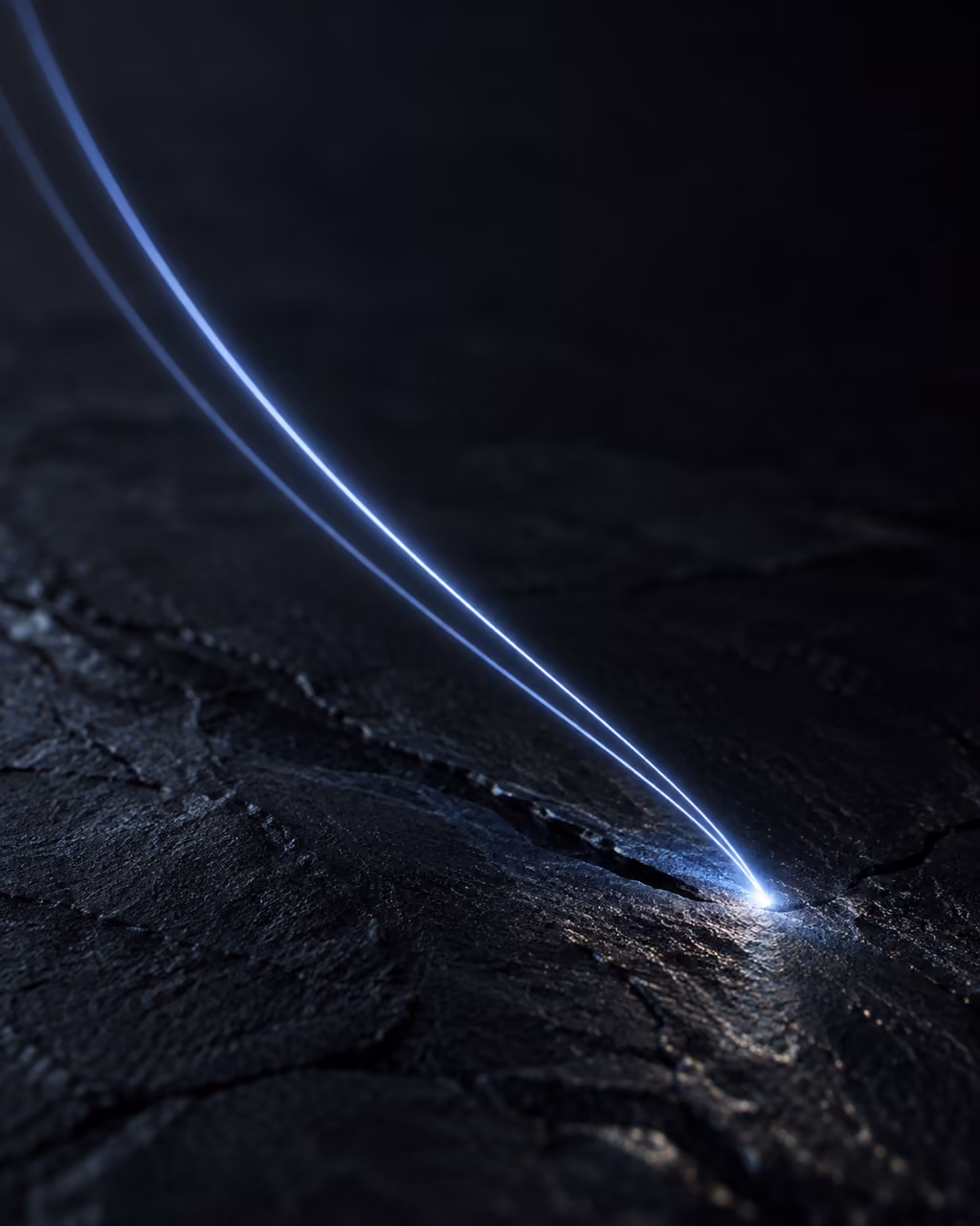 Two blue light threads, one fainter, landing on the same point of a slate surface.